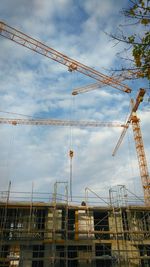 Low angle view of construction site against sky