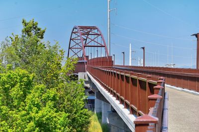 Bridge by buildings against sky