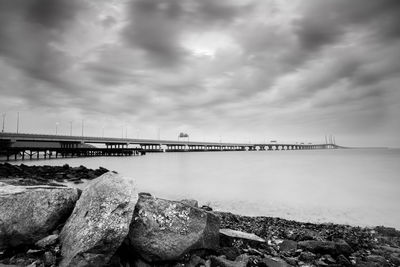 Bridge over sea against sky