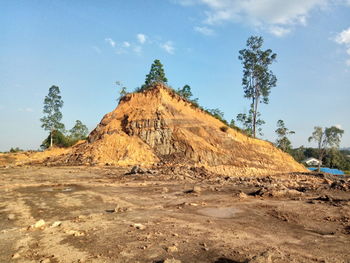 Rock formations on landscape against sky