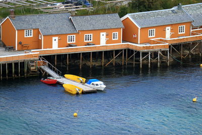 High angle view of nautical vessel on river against buildings