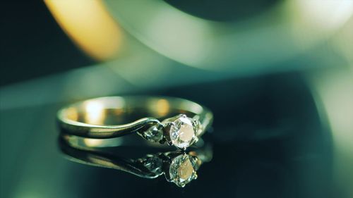 Close-up of diamond ring on table