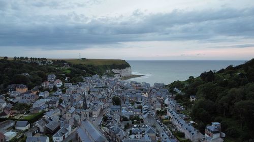 High angle view of townscape by sea against sky