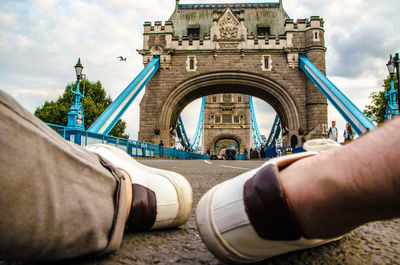 Low angle view of hand against sky in city