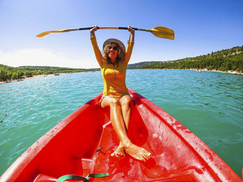 Full length of woman on boat in sea against sky