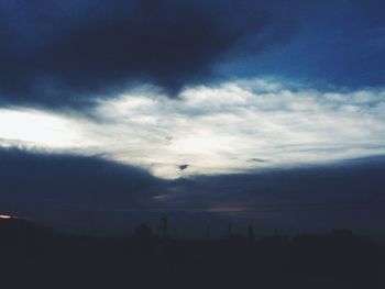 Low angle view of landscape against cloudy sky