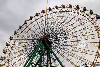 Low angle view of ferris wheel against sky