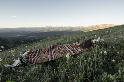 Rug and hat on grass landscape