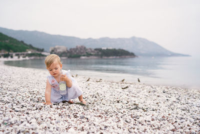 Full length of cute boy on beach