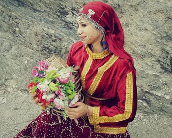 High angle view of smiling woman with bouquet