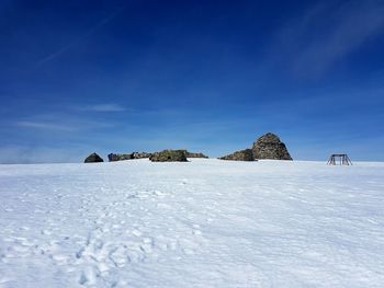 Snow covered land against sky