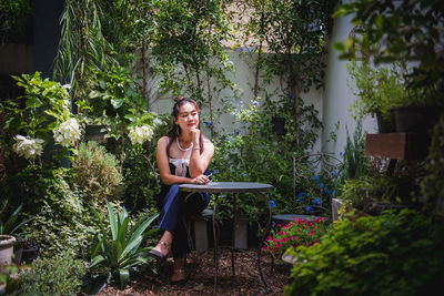 Portrait of a smiling young woman sitting outdoors