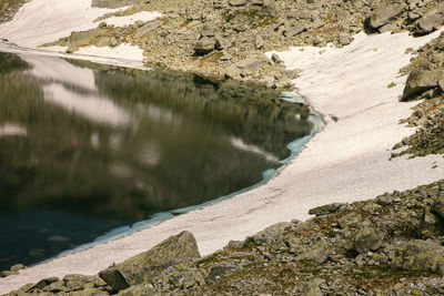 High angle view of rocks by lake