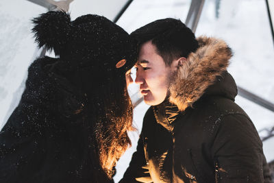 Young couple kissing in snow