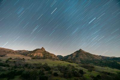 Scenic view of mountains against sky at night