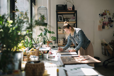 Woman working at desk in workshop