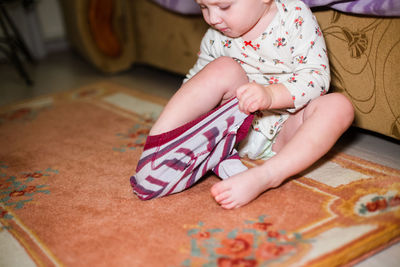 High angle view of cute girl playing with teddy bear