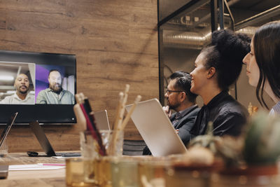 Business colleagues in meeting through video conference at board room