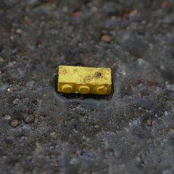 Close-up of yellow toy on rusty metal