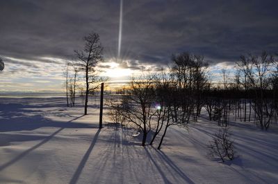 Scenic view of frozen landscape against sky during winter