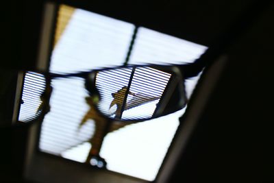 Low angle view of illuminated lamp in darkroom