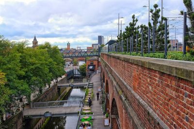 Bridge in city against sky