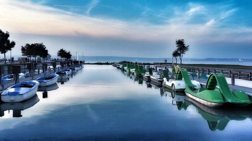 Boats moored in sea against sky