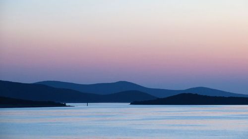 Scenic view of sea against romantic sky at sunset