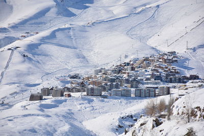 High angle view of houses on snow covered landscape