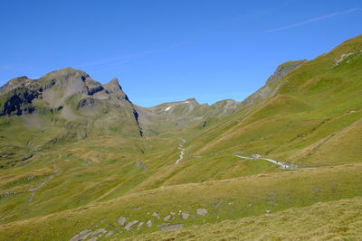 Scenic view of mountains against clear blue sky