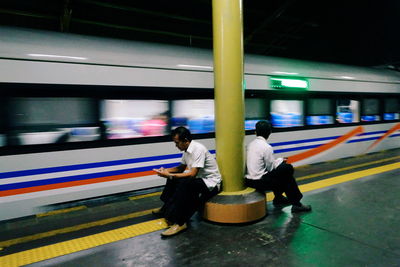 Full length of man and woman at railroad station