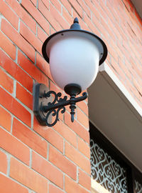 Low angle view of lamp mounted on wall