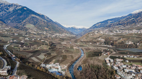 High angle view of road by mountains against sky