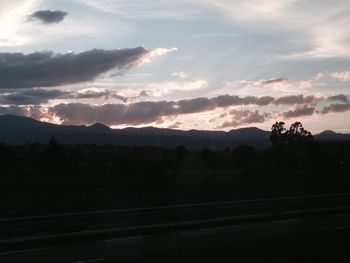 Scenic view of mountains against cloudy sky