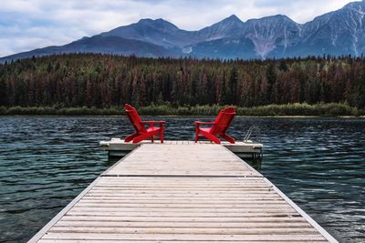 Pier on lake against mountain