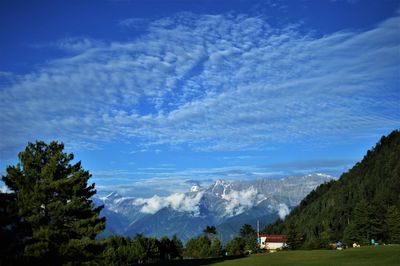 Scenic view of mountains against blue sky