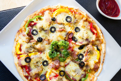 High angle view of pizza served on table