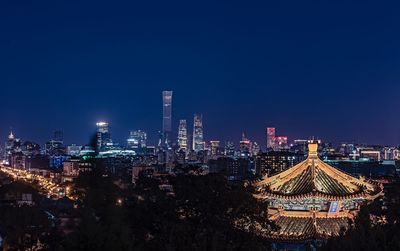 Panoramic view of illuminated buildings against clear sky at night