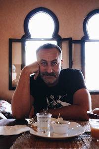 Portrait of young woman sitting at home