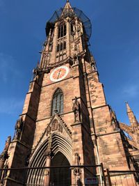 Low angle view of clock tower against sky