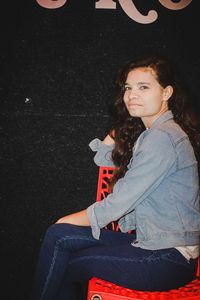 Portrait of smiling young woman sitting outdoors