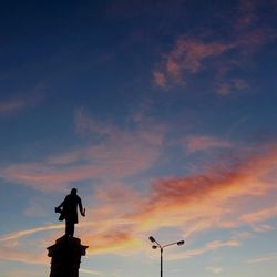 Silhouette statue against sky during sunset