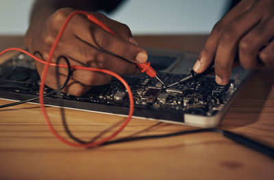 Cropped image of man using computer keyboard