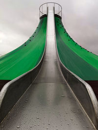 Panoramic view of a metal slide against sky