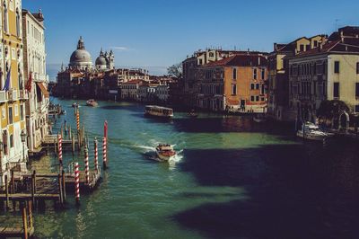 View of boats in canal along buildings