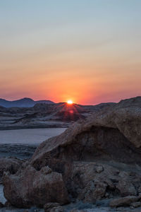 Scenic view of rocky mountains against sky during sunset