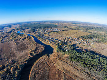 Aerial view of agricultural landscape against clear blue sky