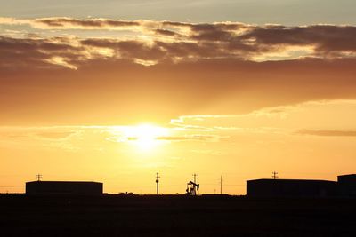 Golden light and pump jack silhouette