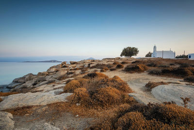 Rocks on beach against clear sky