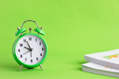 Close-up of clock on table against wall